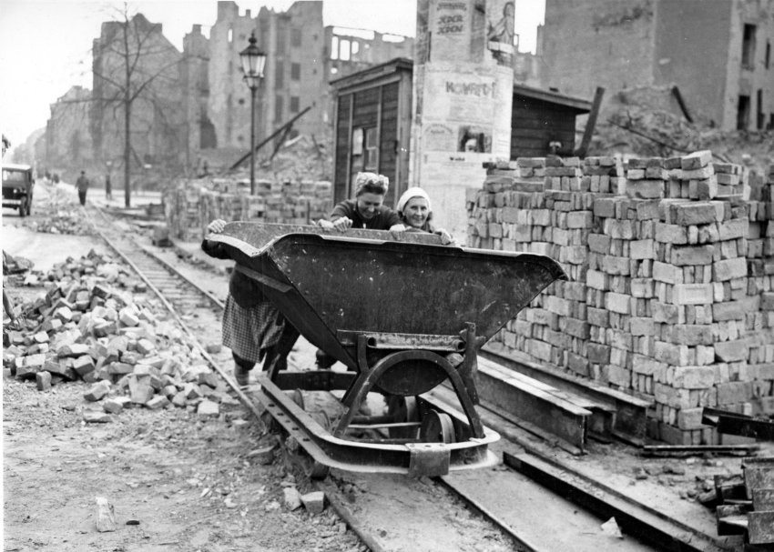 Two of the many thousand so called rubble women (Truemmerfrauen) push a wheel barrow like container in the totally bombed out Berlin, Germany, December 22, 1948. (AP Photo)